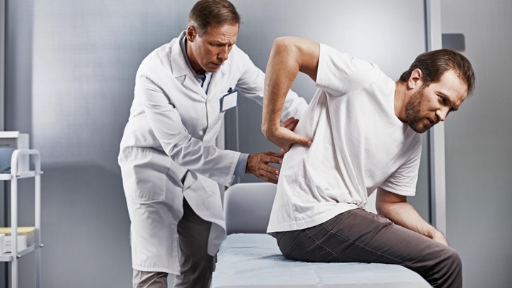 Pain doctor treating male patient